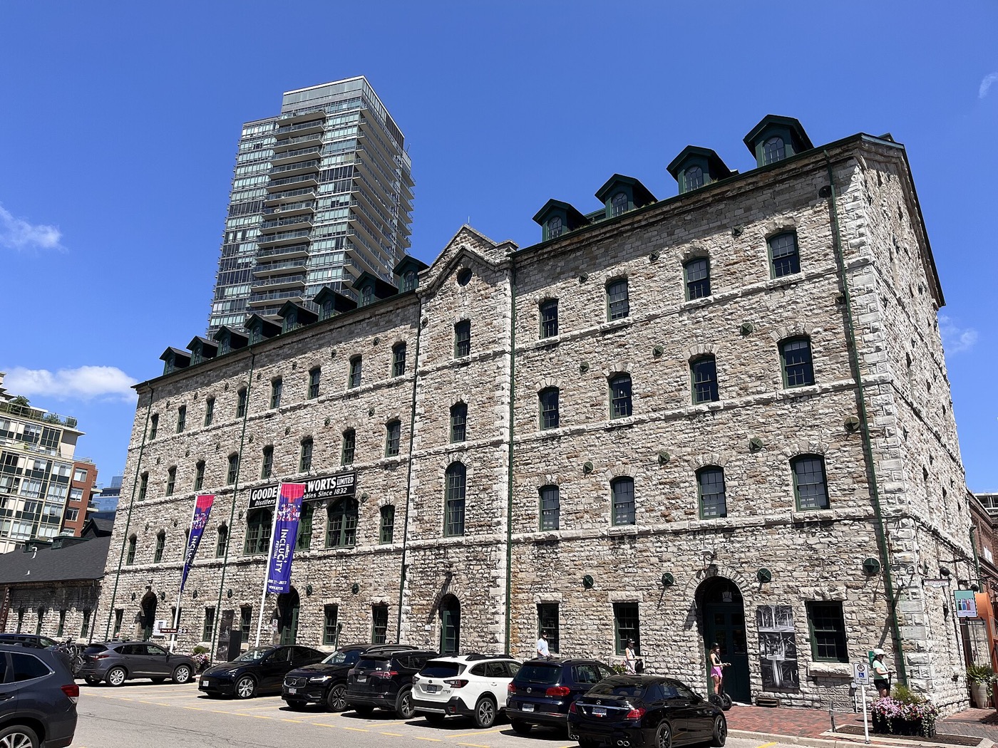 The Fermenting Cellar in Toronto's Distillery District: a multi-storey stone building with dormer windows and a glass tower behind it